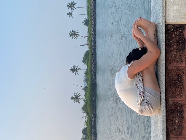 Woman seated on yoga mat