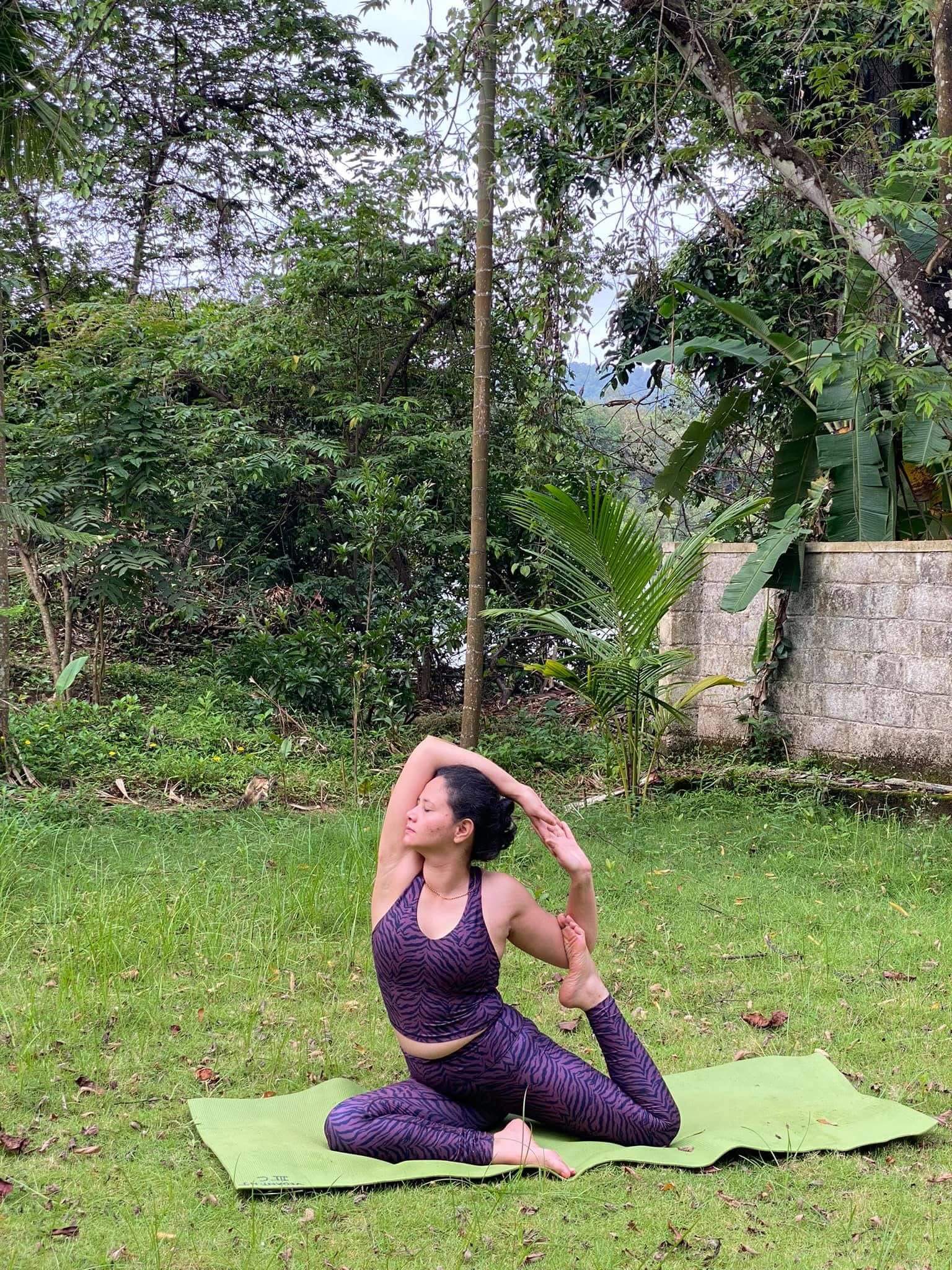 Woman seated on yoga mat