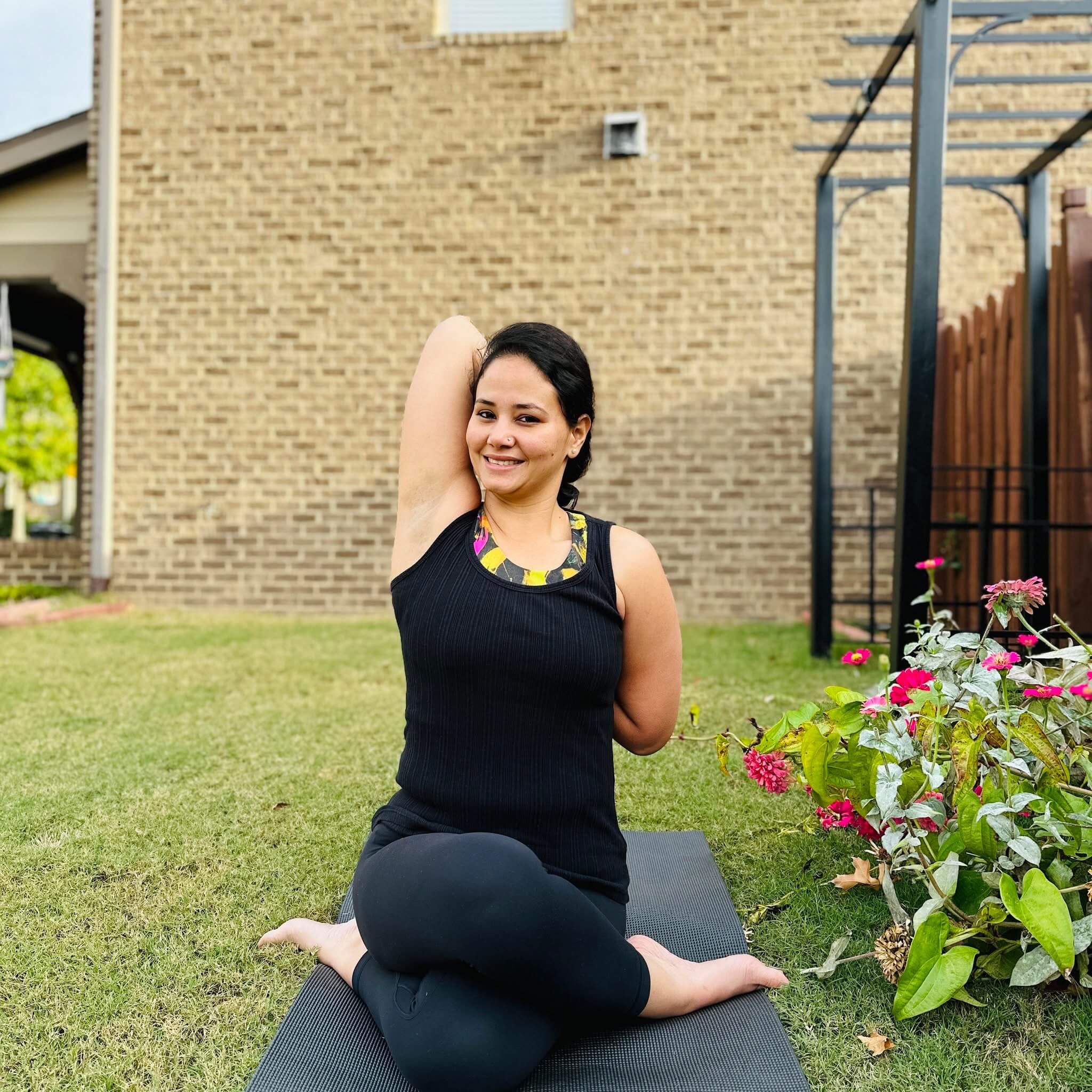 Woman seated on yoga mat