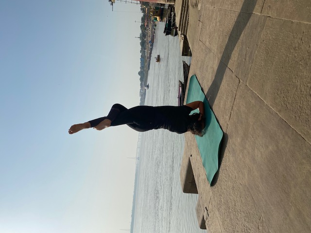 Woman seated on yoga mat