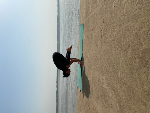 Woman seated on yoga mat