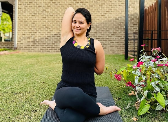 Woman seated on yoga mat