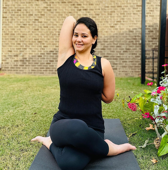 Woman seated on yoga mat